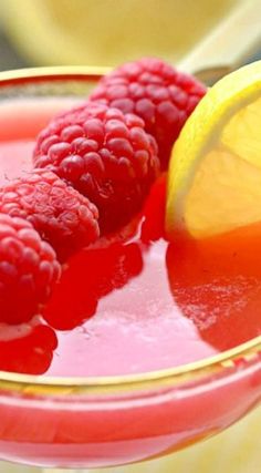 raspberry lemonade punch in a glass with garnish