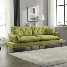 a living room with a green couch and rug