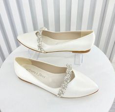 two pairs of white wedding shoes with crystal embellishments