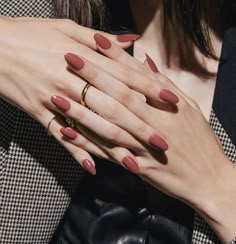 a woman's hands with red nail polish and gold ring