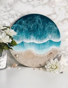 a blue and white plate sitting on top of a table next to some sea shells