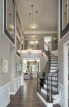 a large open floor plan with stairs and chandelier