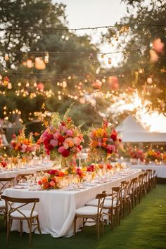 a long table with flowers and candles is set up for an outdoor dinner or party