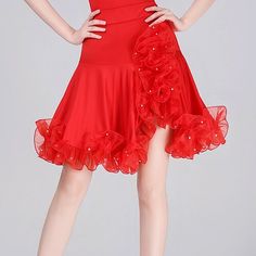 a woman is wearing a red dress with flowers on it