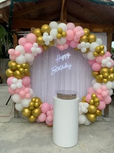 a happy birthday balloon arch with pink, white and gold balloons in the shape of a wreath