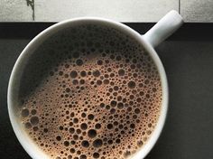 a cup of coffee sitting on top of a counter