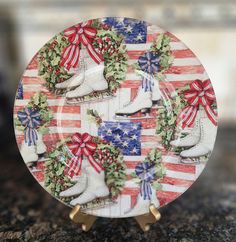 an american flag plate with snow boots and wreaths on the front, sitting on a granite countertop