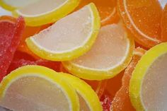 some oranges and lemon slices are covered in sugar