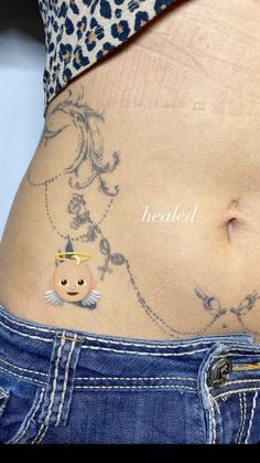 a woman's stomach with tattoos on it