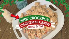 a white platter filled with cookies and candy on top of a wooden table next to christmas decorations