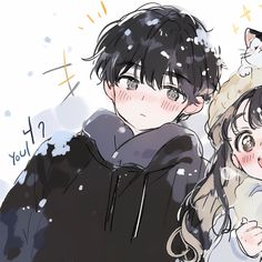 two people standing next to each other with snow falling on them and one cat sitting on top of the man's shoulders