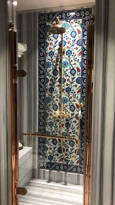 an ornate shower in the corner of a room