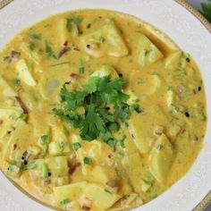 a white bowl filled with food and garnished with cilantro on top