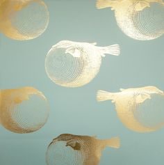 three gold fish floating in the air on a blue background with white and black circles