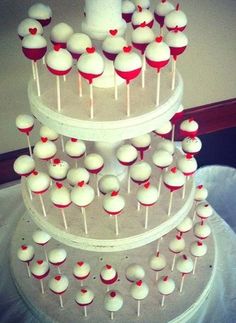 a three tiered cake with red and white candies on it