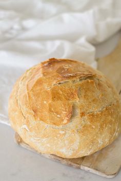 a loaf of bread sitting on top of a cutting board