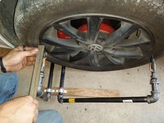 a man is working on a car tire