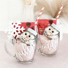 two mugs that have snowmen in them