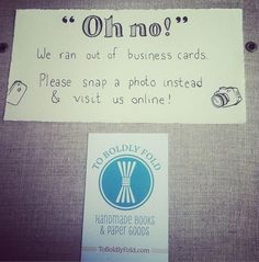 there is a sign on the wall that says oh no? we ran out of business cards please snap a photo instead & visit us online