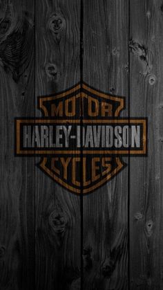 the harley davidson logo on a wooden wall