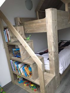 a bunk bed made out of wood with bookshelves on the bottom and shelves below