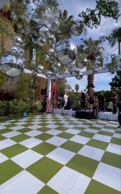 an outdoor dance floor with disco balls hanging from the ceiling