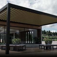 an outdoor covered patio with picnic tables and potted plants