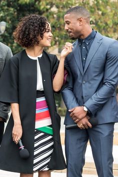 a man and woman standing next to each other