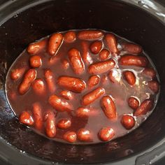 hot dogs are being cooked in the slow cooker