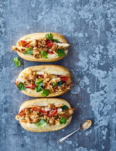 three open faced sandwiches with meat and vegetables