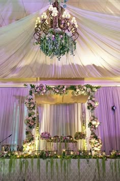 an elegant wedding setup with chandelier and flowers