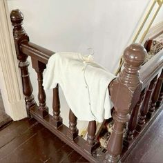 a white blanket sitting on top of a wooden banister