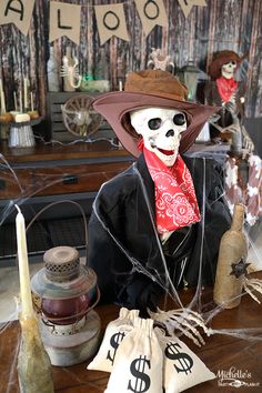 a skeleton wearing a hat and scarf sitting in front of some bags with dollar signs on them