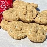 several cookies are stacked on top of each other next to a red bag and some candy