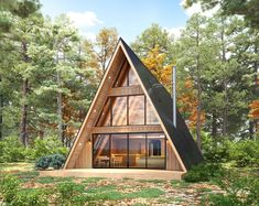 a - frame cabin in the woods surrounded by trees