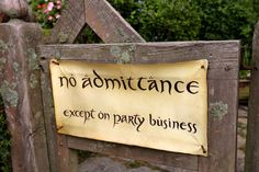 a wooden fence with a sign that says no admittance except on party business