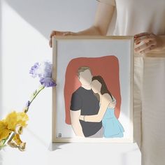 a woman holding a framed photo of a man and woman with flowers in front of her