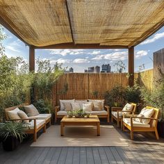 an outdoor living area with couches and tables