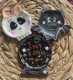 three halloween magnets sitting on top of a basket