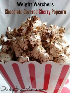 chocolate covered cherry popcorn in a red and white striped paper bowl with text overlay