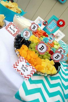 a table topped with lots of fruit and snacks