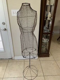 a wire mannequin on display in front of a door