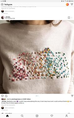 a woman wearing a white sweater with colorful beads on it and the words love is written in