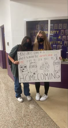 two girls holding a sign that says, you are one and the world is dying