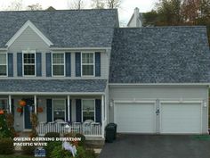 a large house with blue shutters and white trim