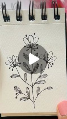 a notepad with a drawing of flowers on it