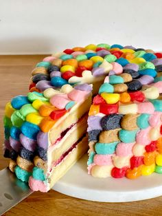 a cake that has been cut into pieces and is decorated with candy candies on top