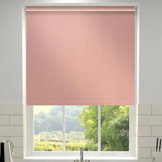 a pink roller shade in a kitchen window