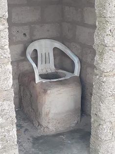 a white chair sitting on top of a cement block