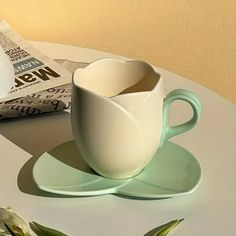 a cup and saucer sitting on a table